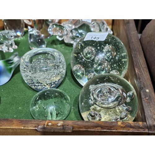 149 - A collection of assorted size glass bubble paperweights, one of which can be used as a tealight hold... 