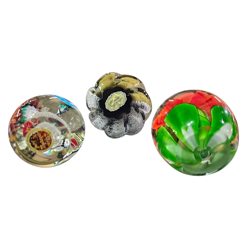 161 - Pair of labelled Murano glass paperweights together with an unmarked floral paperweight