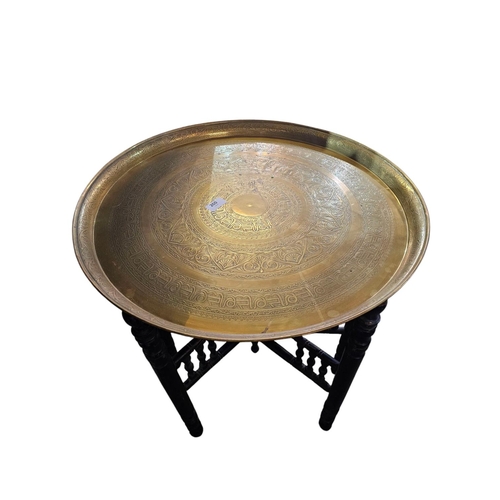 260 - Indian brass charger table top on wooden turned bass 57cm in diameter