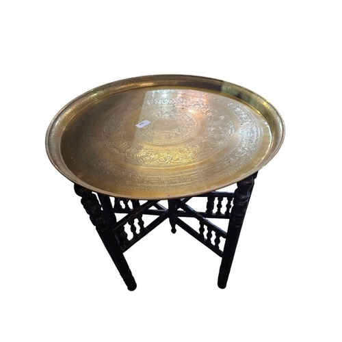 260 - Indian brass charger table top on wooden turned bass 57cm in diameter