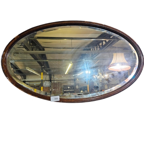 306 - Large Victorian wooden framed oval mirror with carved detail