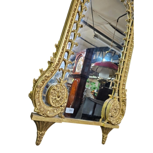 311 - A Classical style carved gilt wood wall mirror, the shaped retangular plate surmounted by a ribbon t... 