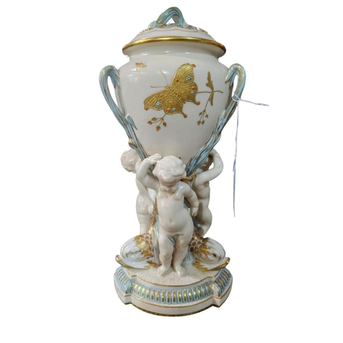 339 - A Minton Parian ware comport, the lattice basket supported upon a cornucopia held by a cherub with g... 