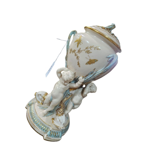 339 - A Minton Parian ware comport, the lattice basket supported upon a cornucopia held by a cherub with g... 