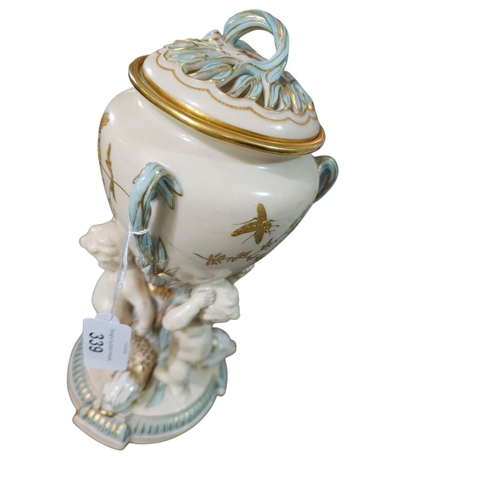 339 - A Minton Parian ware comport, the lattice basket supported upon a cornucopia held by a cherub with g... 