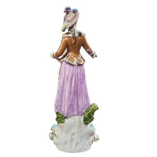 368 - A Continental porcelain figure of a duelling lady, poised with a pistol in hand, wearing a brightly ... 