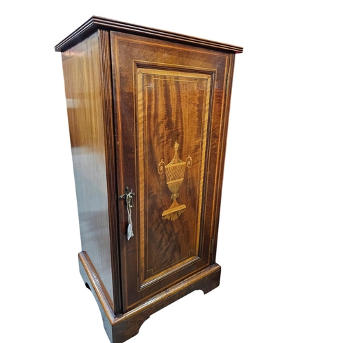 386 - An Edwardian mahogany, night cupboard with satin, wood and boxwood line inlay. The single panel door... 