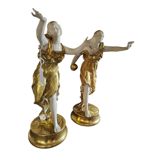 388 - A pair of Royal Worcester short gold porcelain figurines modelled as neo-classical ladies wearing di... 