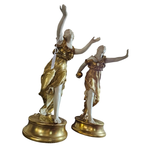 388 - A pair of Royal Worcester short gold porcelain figurines modelled as neo-classical ladies wearing di... 