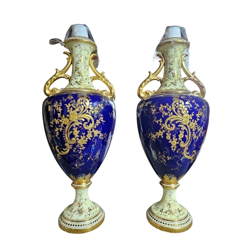 389 - A pair of Coalport porcelain pedestal vases and covers, painted by F. Howard with panels of fruit wi... 