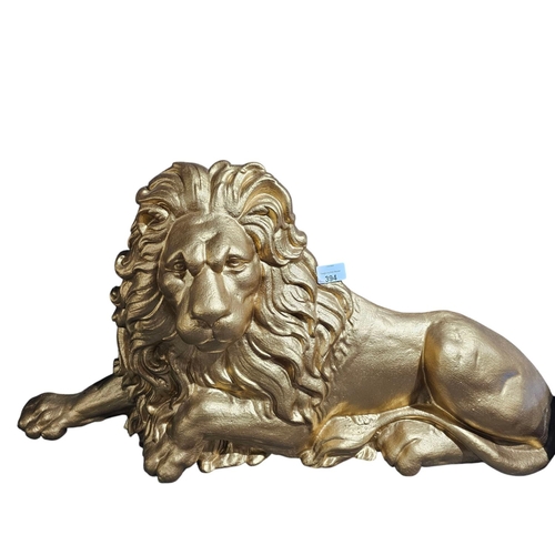 394 - Large cast Iron lion sprayed gold 69cm in length