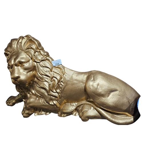 394 - Large cast Iron lion sprayed gold 69cm in length