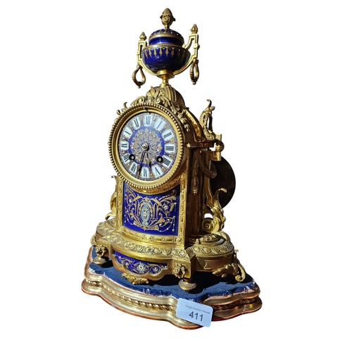 411 - A late 19th century French gilt bronze clock garnature, with ground sèvres panel decoration the circ... 