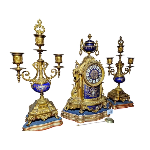 411 - A late 19th century French gilt bronze clock garnature, with ground sèvres panel decoration the circ... 