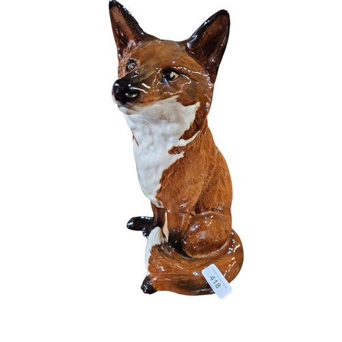 418 - A Beswick model of a seated fox impressed model number 234831 cm high.