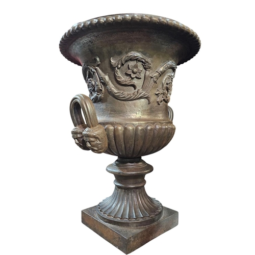 429 - A pair of Victorian cast iron twin handled Campana garden urns with lobbed rim and lower body with s... 