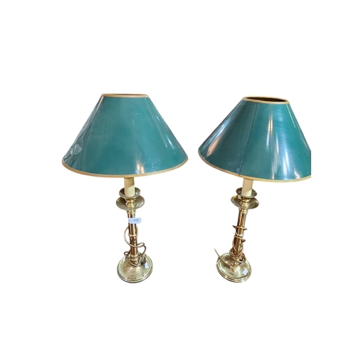 436 - Pair of brass candle stick lamps with green shades