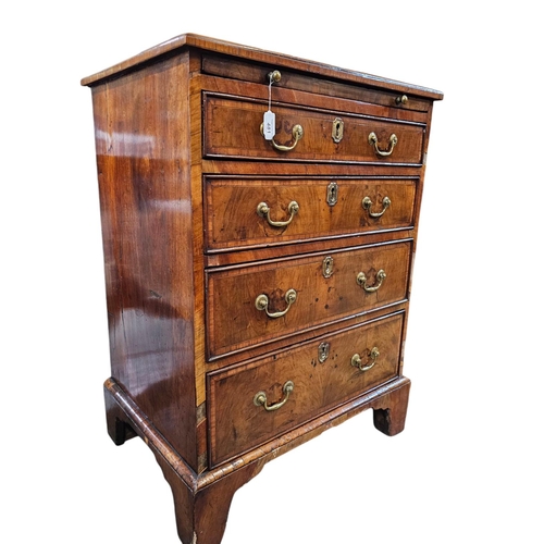 481 - An 18th century walnut and satinwood cross banded chest of 4 long drawers beneath a brushing slide w... 