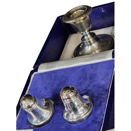 685 - Cased set of fully hallmarked salt and pepper set and candle holder