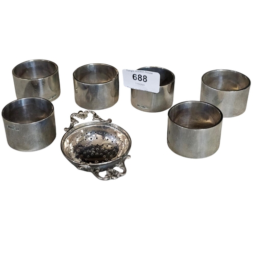 688 - Set of 6 silver hallmarked napkin rings 62g in weight EACH and antique silver hallmarked tea straine... 