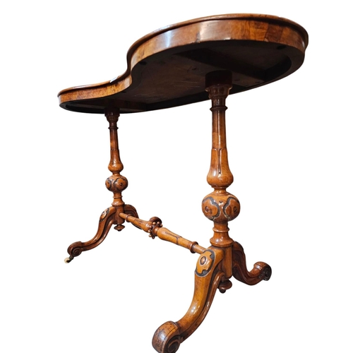 694 - A Victorian figured walnut kidney shaped writing table with green leather insert raised on turned an... 