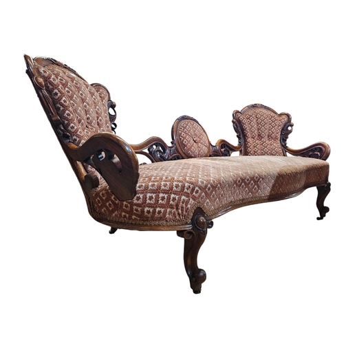 695 - A Victorian walnut double end settee with elaborate pierced and carved scrolling show frame with aca... 