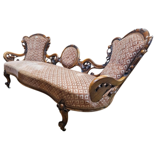 695 - A Victorian walnut double end settee with elaborate pierced and carved scrolling show frame with aca... 