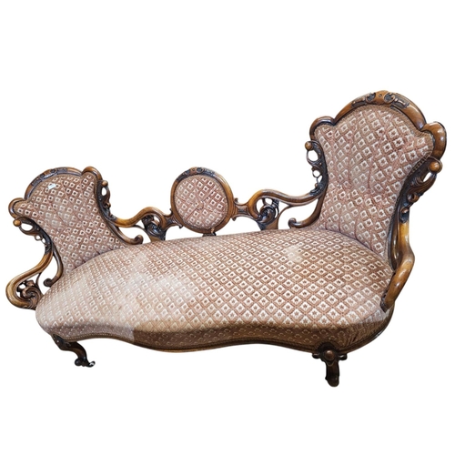 695 - A Victorian walnut double end settee with elaborate pierced and carved scrolling show frame with aca... 