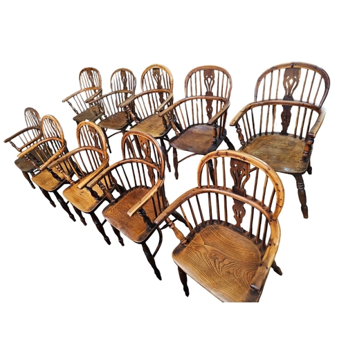 706 - A Harlequin set of 10 Victorian yew wood  Windsor elbow chairs each with low back centered by a pier... 