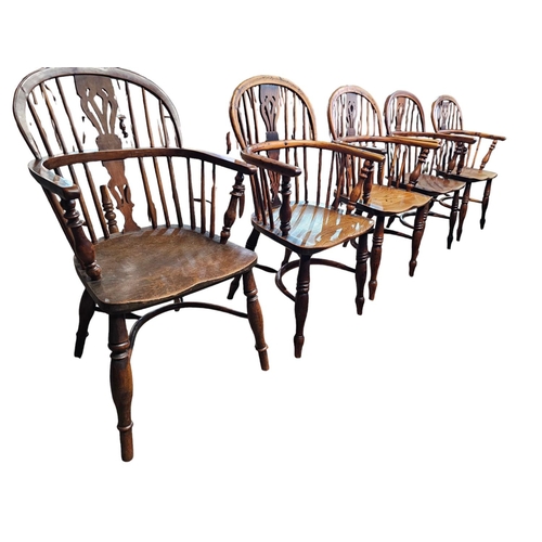 706 - A Harlequin set of 10 Victorian yew wood  Windsor elbow chairs each with low back centered by a pier... 