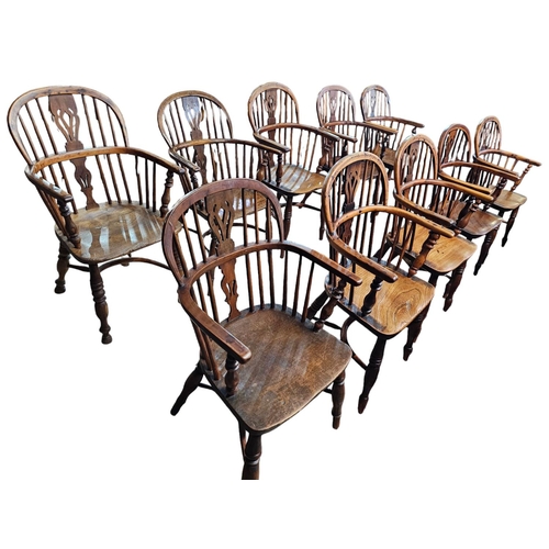 706 - A Harlequin set of 10 Victorian yew wood  Windsor elbow chairs each with low back centered by a pier... 