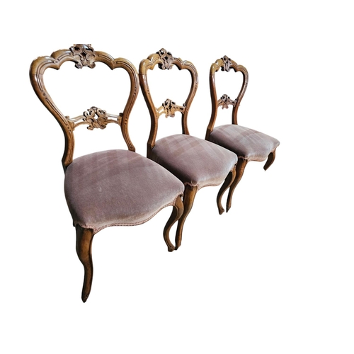 714 - Set of 7 Victorian faded walnut parlour chairs with loon back style, with carved Central cresting to... 