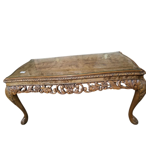 723 - A quality carved antique walnut table with glass top