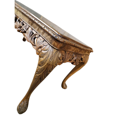 723 - A quality carved antique walnut table with glass top