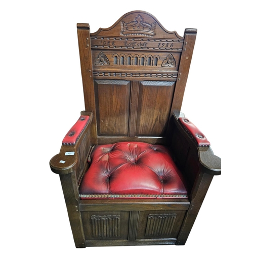 728 - Solid oak ' Doomsday chair' inscribed 1086 -1986 with red leather deep button seat and arms. 51