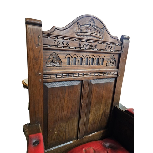 728 - Solid oak ' Doomsday chair' inscribed 1086 -1986 with red leather deep button seat and arms. 51