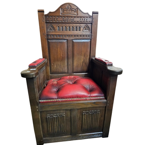 728 - Solid oak ' Doomsday chair' inscribed 1086 -1986 with red leather deep button seat and arms. 51