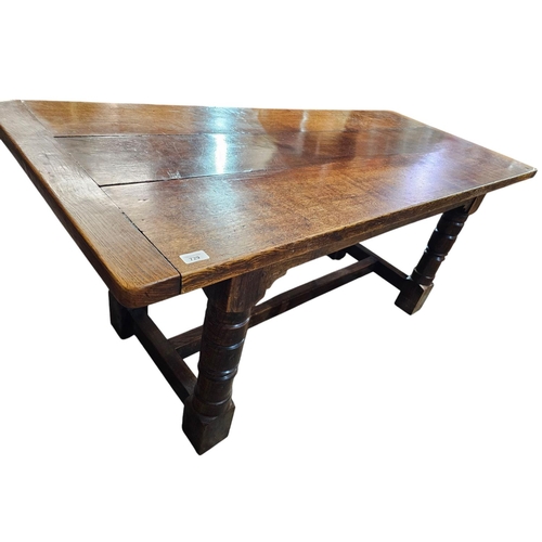 729 - A 17th century style oak refectory type table rectangular top with drawer leaves  and it's raised on... 