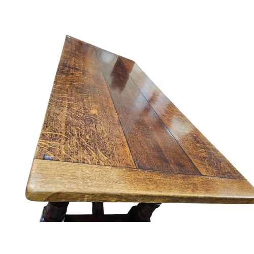 729 - A 17th century style oak refectory type table rectangular top with drawer leaves  and it's raised on... 