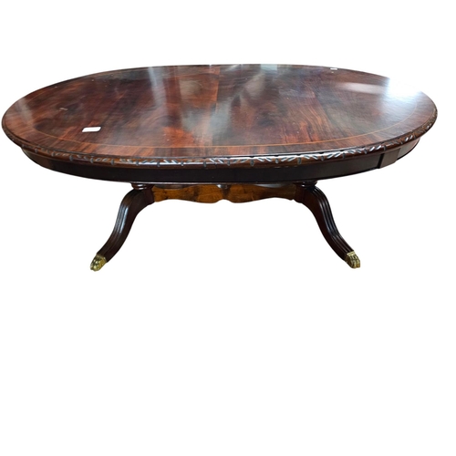 735 - Low mahogany long pedestal table with brass claw feet and central stretcher