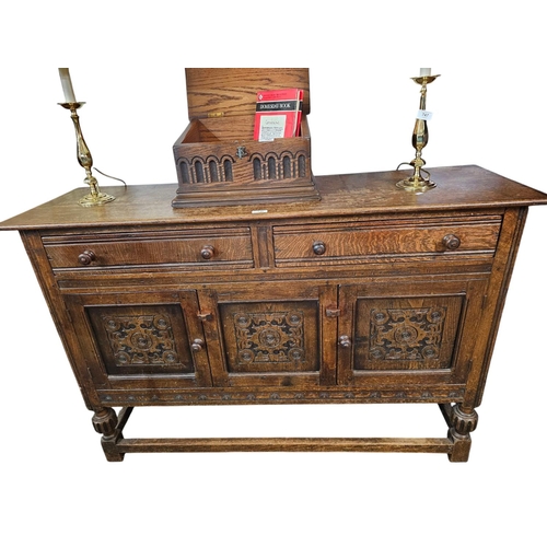 746 - 1920s oak side board with heavily carved doors and 2 drawers