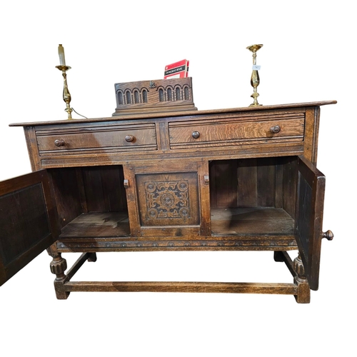 746 - 1920s oak side board with heavily carved doors and 2 drawers