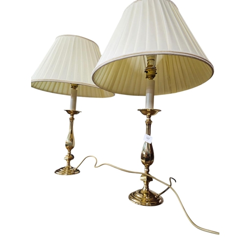 747 - Pair of brass candle stick style table lamps with cream shades