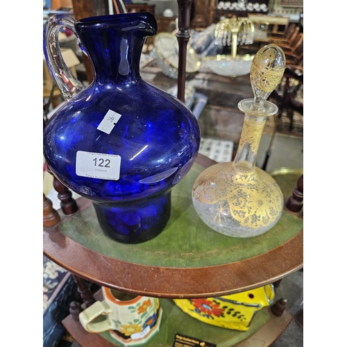 122 - Heavy blue glass jug with clear glass handle together with decorative Italian glass bottle with stop... 