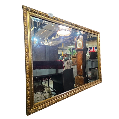 307 - Bevelled edge gold surround rectangular mirror 82xm x 57cm