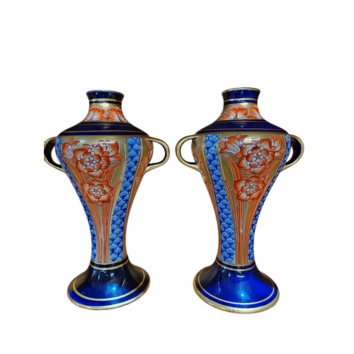 488 - A stunning pair of  Moorcroft MacIntyre, twin handle vases of inverted ballaster form painted in und... 