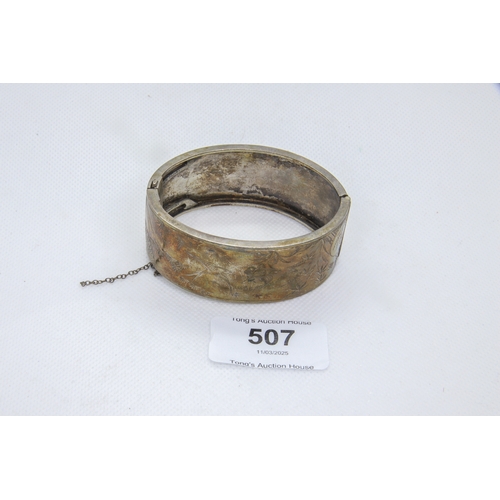 507 - Large white metal bangle, 33.4 g in total.