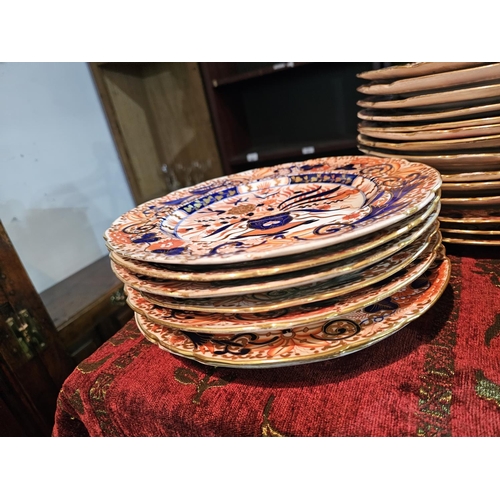 413 - A early 19th century Derby porcelain Imari dinner service of indented form, comprising a twin handle... 