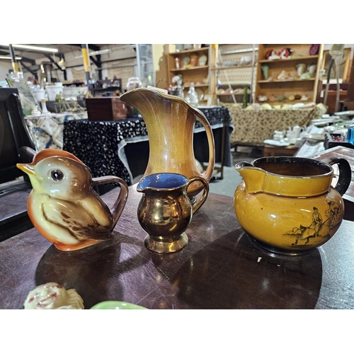 32 - Collection of four vintage jugs to include Robin water pitcher, Royal Winton and Coaching Days