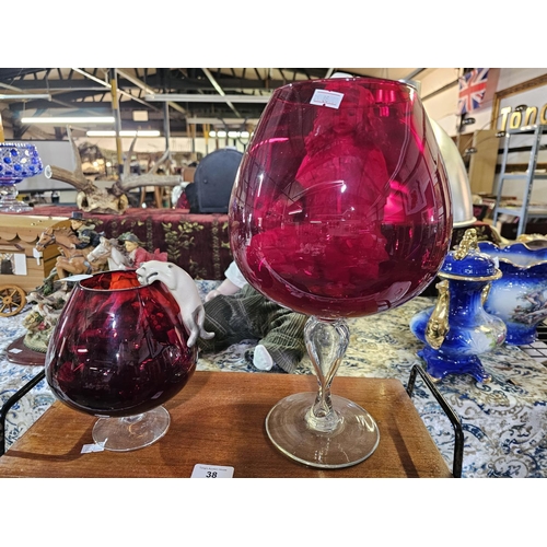 40 - Two large ruby glasses one with cat and mouse figurines